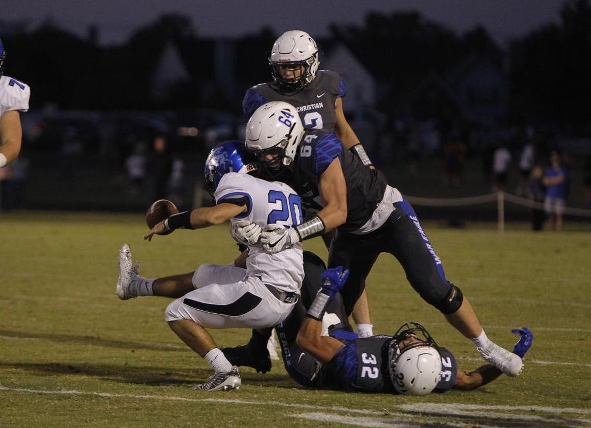 LCA's Walker Parker knocks the ball loose as he tackles Lexington Catholic's Keith Brinkman at Lexington Christian Academy in Lexington, Ky., Friday, September 8, 2017.