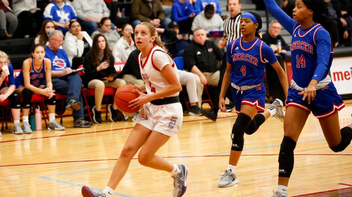 West Jessamine’s Novalee Smith, left, drives toward the basket on a fast break as Mercer County’s Annie Releford (4) and Cardin Sickles (14) try to chase her down during the Colts’ 58-37 win over the Titans at West Jessamine High School in Nicholasville on Friday.