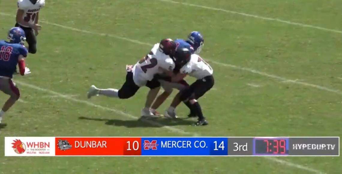 Paul Laurence Dunbar’s Ethan Hampton (52) at left, collided with a teammate on a tackle during the Bulldogs’ game at Mercer County at Alvis Johnson Field in Harrodsburg on Aug. 26. Hampton believes this initial hit triggered his career-ending injury.