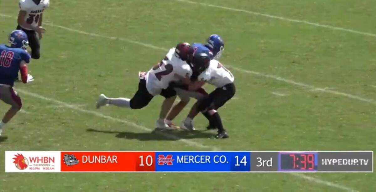 Paul Laurence Dunbar’s Ethan Hampton (52) at left, collided with a teammate on a tackle during the Bulldogs’ game at Mercer County at Alvis Johnson Field in Harrodsburg on Aug. 26. Hampton believes this initial hit triggered his career-ending injury.
