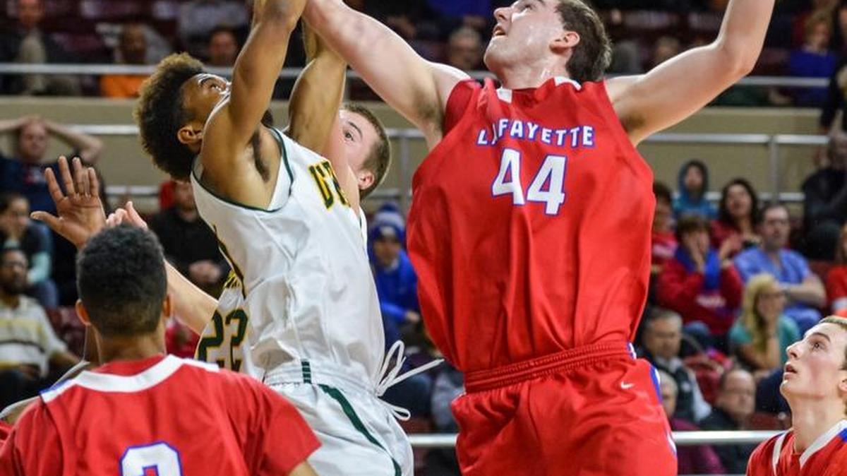 Lafayette’s Ross Jenkins rebounds over Bryan Station's Tim Dunn, during the boys 11th Region semifinals, Monday night, March 9, 2015, at McBrayer Arena in Richmond. Bryan Station won 65-48.