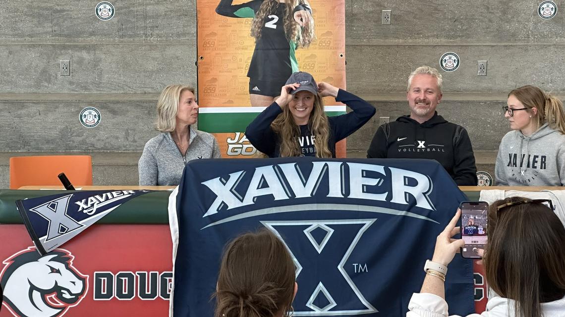 Frederick Douglass volleyball’s Jamison Gordon dons a Xavier hat at her signing day ceremony at Frederick Douglass High School on Wednesday, Nov. 9, 2022