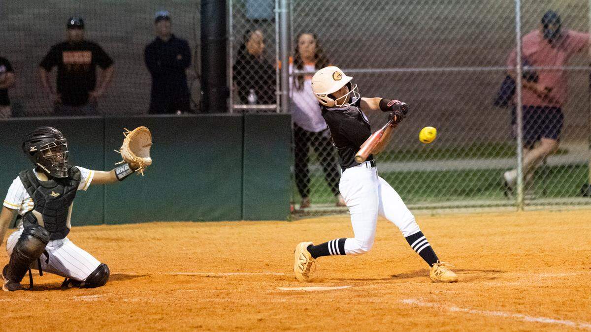 Frederick Douglass’ Emma Dunn swings into a go-ahead home run to left field in the sixth inning of the Broncos’ 3-2 win against Bryan Station in the 42nd District softball tournament semifinals at Frederick Douglass High School on Monday.