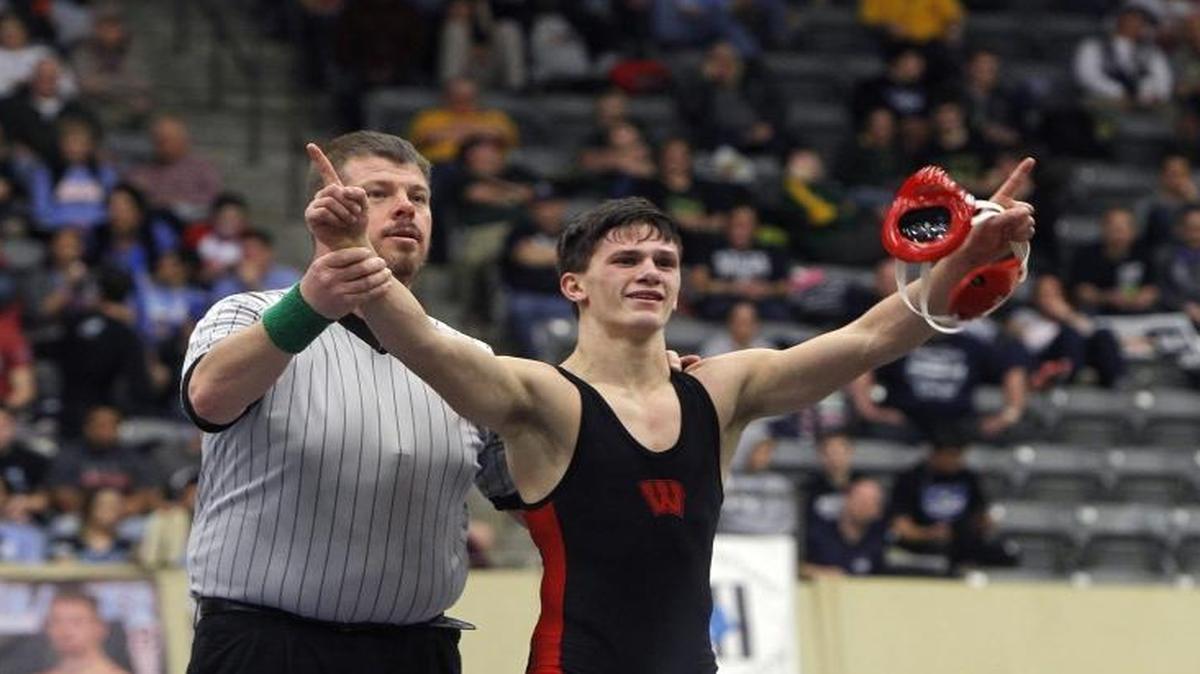 Wayne County's Cagen Wallace has his arm raised as state champion the 113-lb class at the KHSAA State Wrestling Championship at Alltech Arena in Lexington, Ky., Saturday, February 18, 2017.