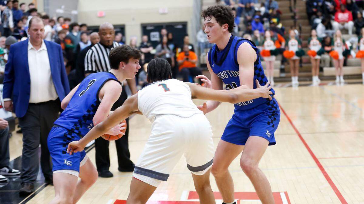 Lexington Catholic’s Rowen Williams, right, set a pick on Frederick Douglass’ Armelo Boone (1) as teammate Tyler Doyle (3) looked for an opening during the boys 11th Region Tournament semifinals at Paul Laurence Dunbar High School in Lexington on Saturday, March 9, 2024.