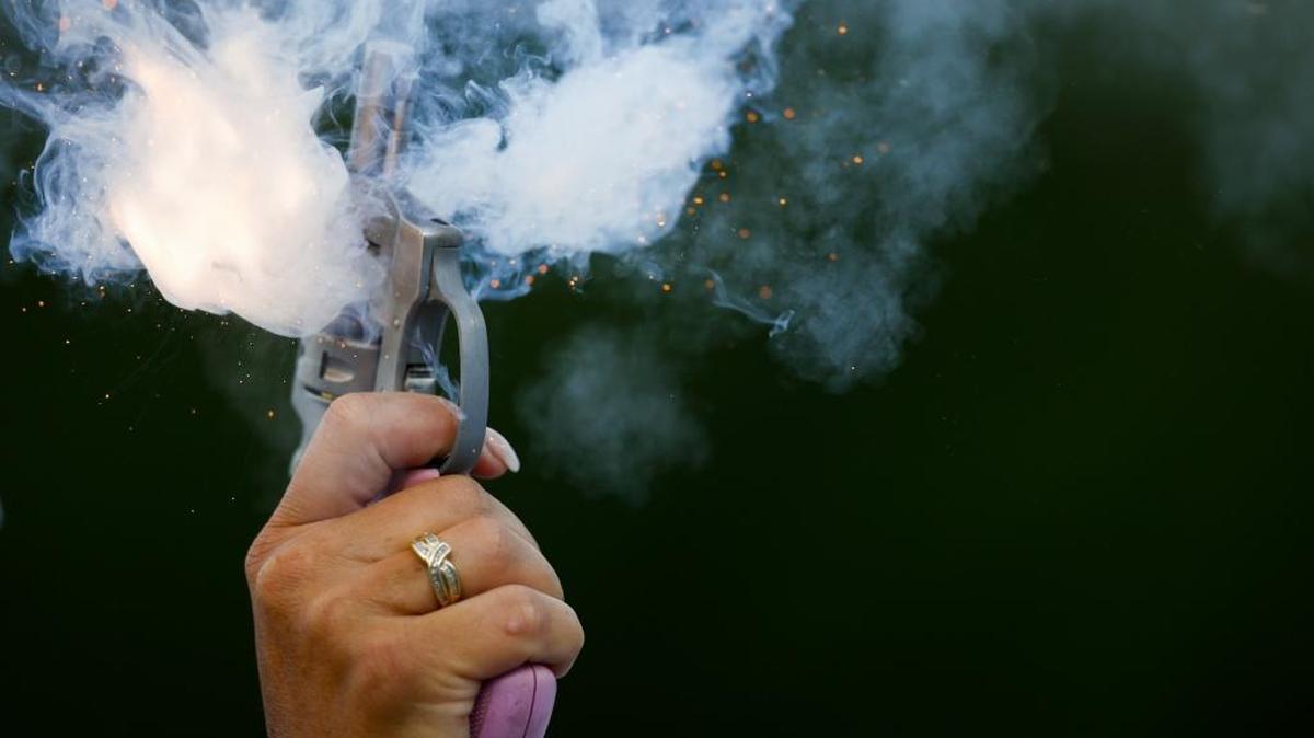 Patty Rouse, of Elizabethtown, Ky., fires a starting pistol during the 2017 KHSAA Track & Field 3A State Meet at the University of Kentucky in Lexington, Ky., Saturday, May 20, 2017.
