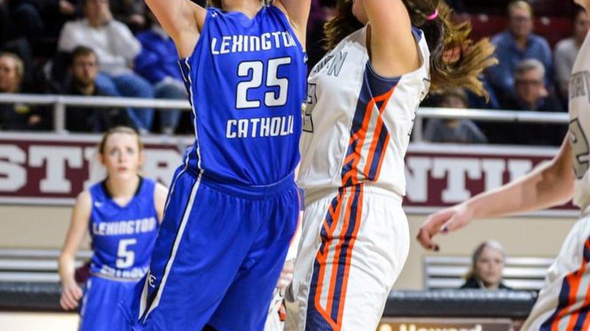 Lexington Catholic's Sarah Bonn shoots around Madison Southern's Marley Lawson, during the opening round of the girls 11th Region Tournament, Monday night, March 2, 2015, at McBrayer Arena in Richmond. Madison Southern won 48-41.