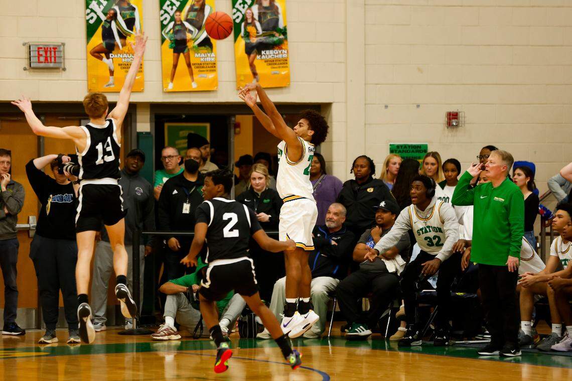Bryan Station’s Rashaad Faulkner, center, shoots a 3-pointer over Frederick Douglass’ Tate Robinson (13) as Defenders’ coach Champ Ligon, right, looks on during their game at Bryan Station High School on Friday. Faulkner made three 3s in the second half, including this one.