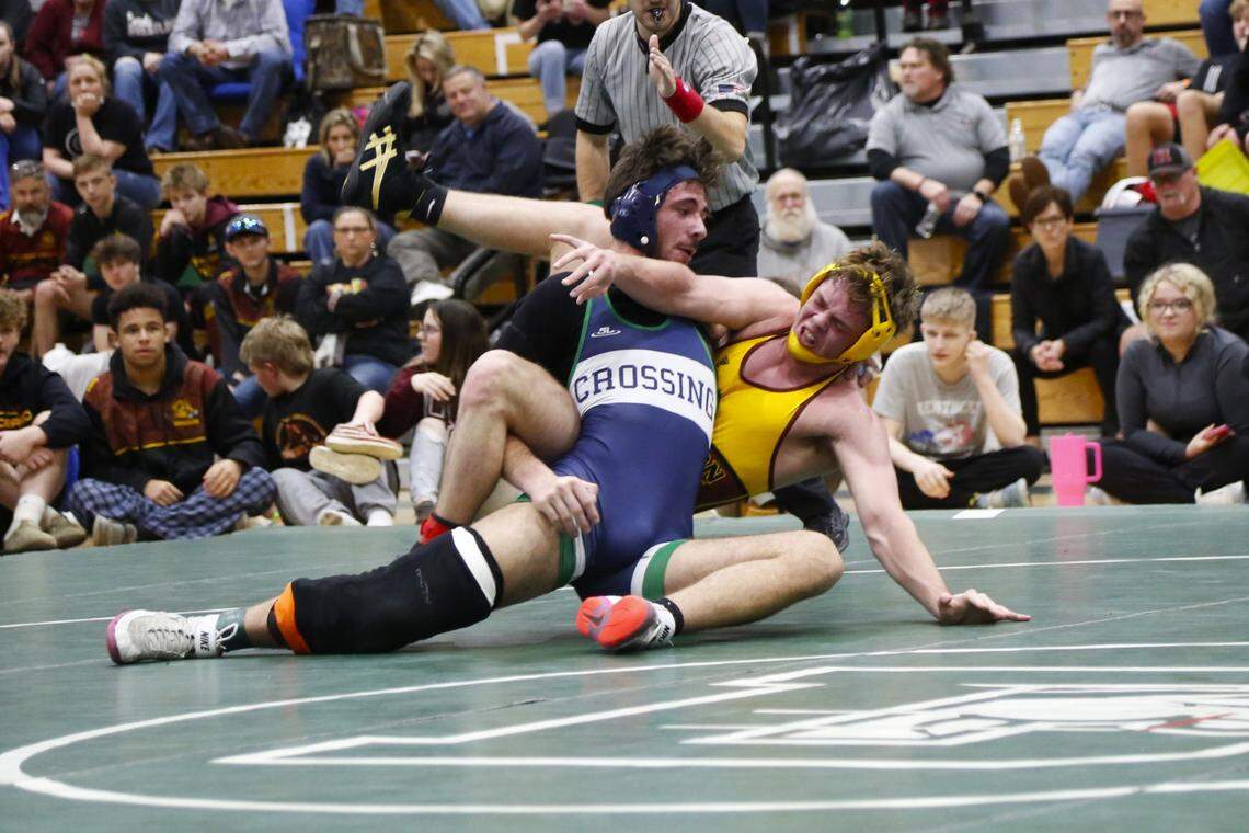 Great Crossing’s Joshua Strayer, left, leaned into Harrison County’s Logan Dingus in their 175 finals match at the Region 6 Championships at Frederick Douglass High School in Lexington on Saturday, Feb. 10, 2024.