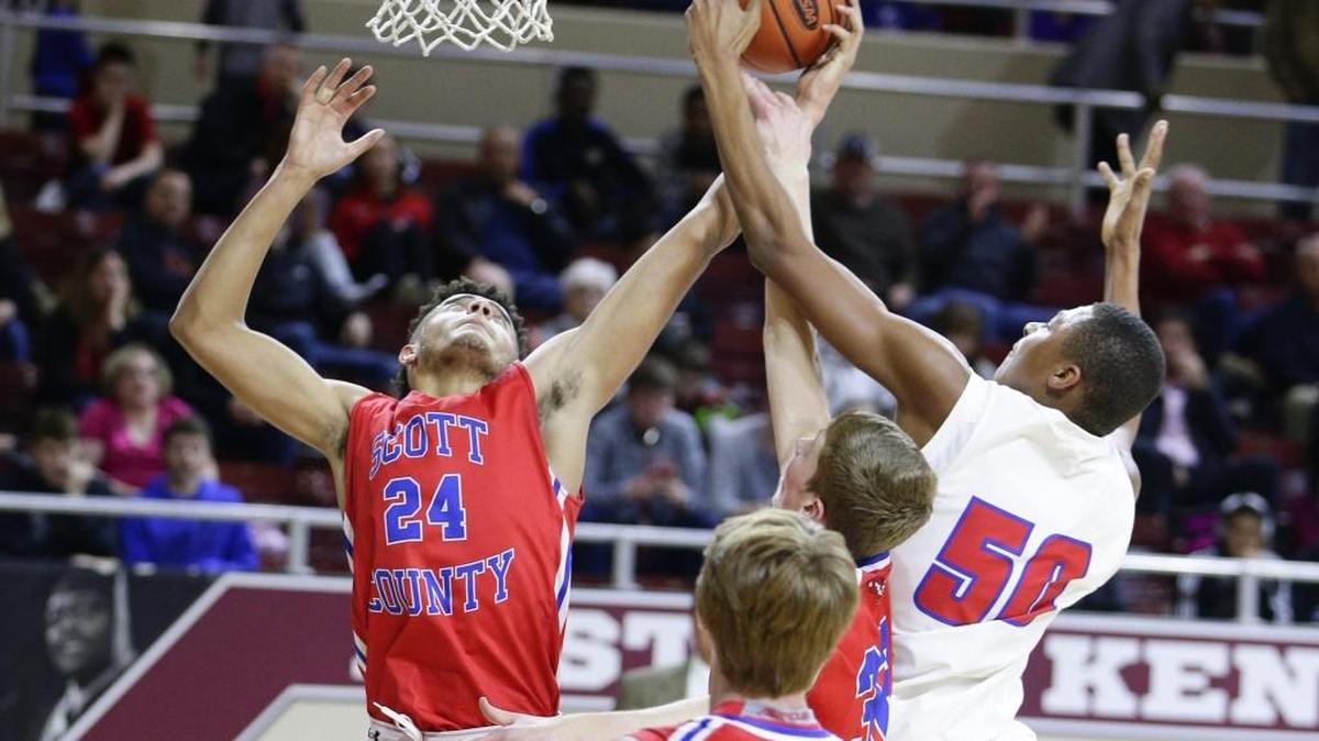 Scott County's Michael Moreno, battled for a rebound with Madison Central's Isaiah Cozart, 50, as Scott County played Madison Central in the 11th region tournament on Wednesday March 2, 2016 in Richmond, Ky.