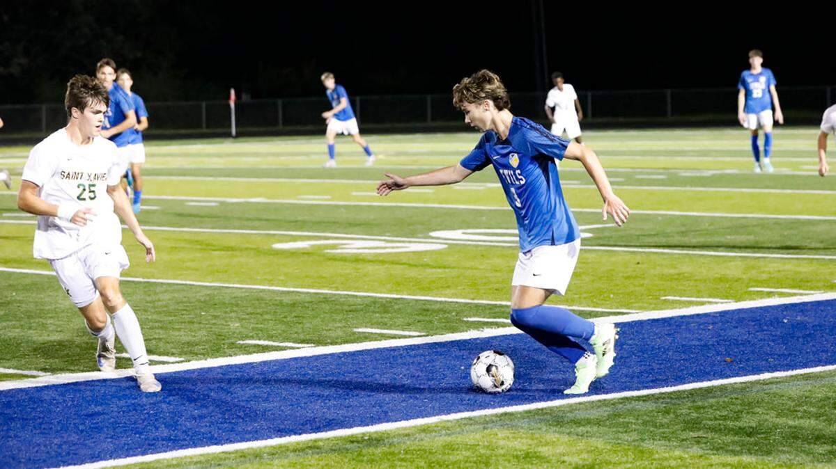 Henry Clay’s Braden Cundiff dribbled the ball up the field while shadowed by St. Xavier’s Robert “Lou” Webber III during the Blue Devils’ 1-1 tie at home against the Shamrocks on Oct. 1.