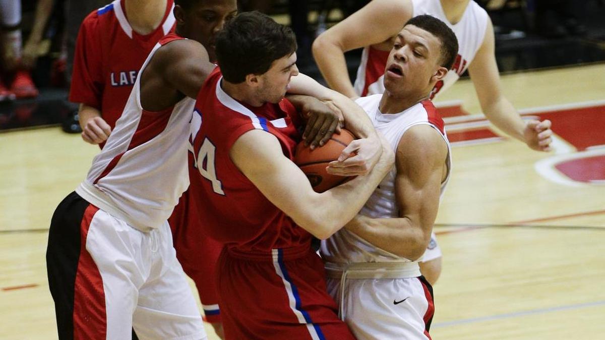 Dunbar's Dontell Brown, left, and Darius Williams, 23, wrestled for a rebound with Lafayette's Ross Jenkins, 44, as Dunbar defeated Lafayette 73-42. on Tuesday January 26, 2016 in Lexington, KY.