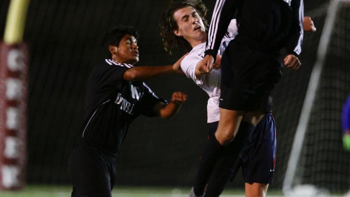 Dunbar's Pedro Jimenez, 19, headed the ball past Lafayette's Nick SirLouis,21, as Dunbar defeated Lafayette 1-0 to win the 43rd district title on Thursday October 13 , 2016 in Lexington, Ky. Photo by Mark Cornelison
