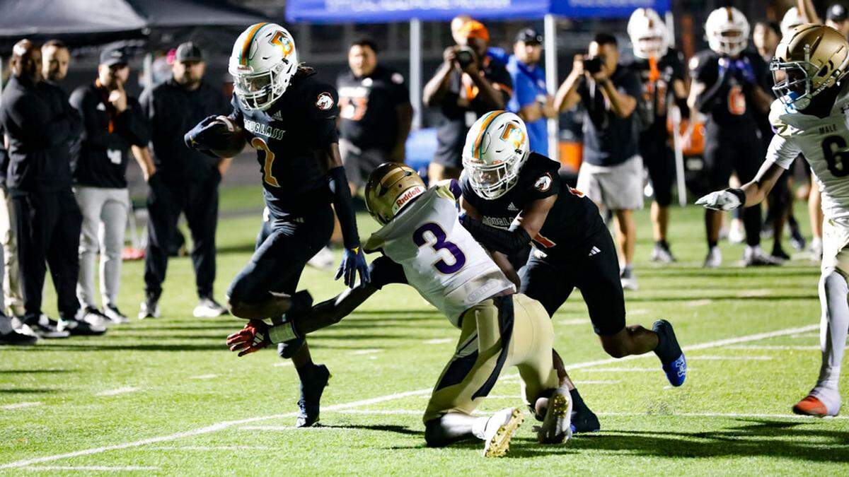 Frederick Douglass wide receiver Aveion Chenault (2) tip-toed the sideline on a 35-yard touchdown catch and run as teammate Dakari Talbert finished a block on Male’s Antonio Harris during the fourth quarter of Male’s 31-28 victory at The Farm in Lexington on Friday, Oct. 4, 2024.