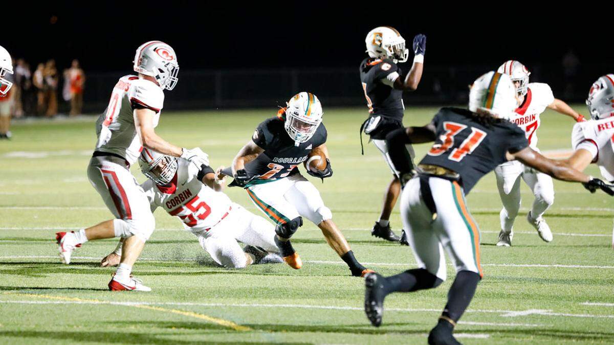 Frederick Douglass running back Peyton Smith (23), breaks a Corbin tackle during the Broncos 35-14 win over the Redhounds at The Farm on Friday.