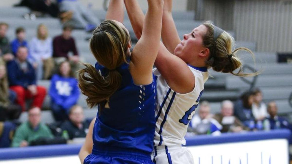 Lexington Catholic's Sarah Bonn, 25, was fouled by Lexington Christian's Payton Rodgers, 4, as she went to the basket as Lexington Catholic defeated Lexington Christian 59-35 on Wednesday January 6, 2016 in Lexington, Ky.