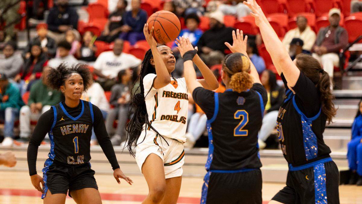 Frederick Douglass guard Tamia Waide (4) puts up a shot in the lane among three Henry Clay defenders, including Ariyana Sutton (1), Charlianne Robinson (2) and Carolyn Young during the Broncos’ 78-44 win in the 42nd District Tournament championship game at Scott County High School’s Billy Hicks Gymnasium in Georgetown on Friday.