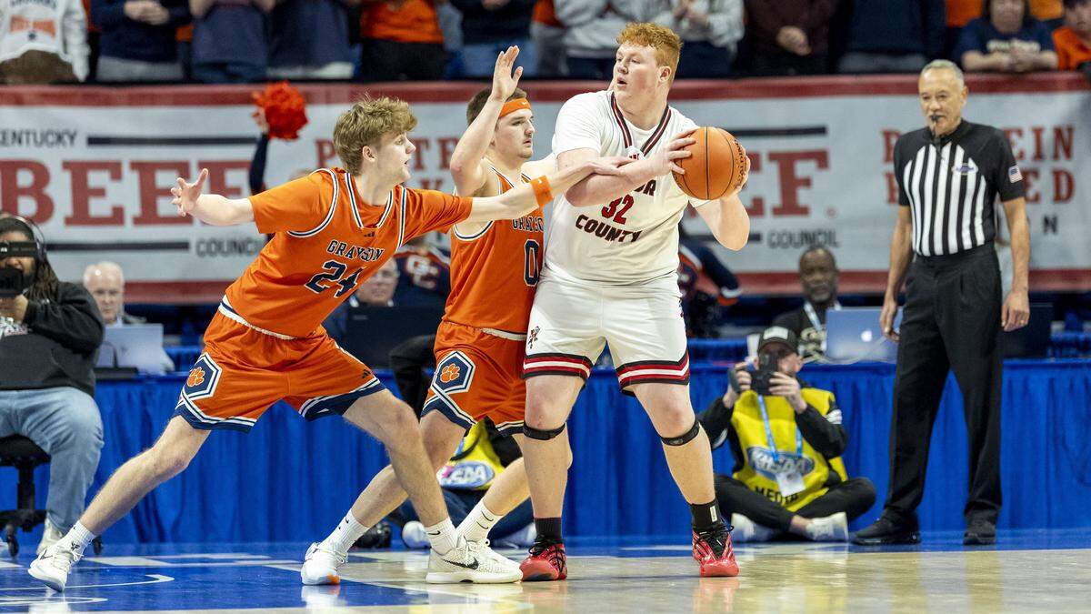 Taylor County's Bryten Close (32) is surrounded by Grayson County's Jack Logsdon (24) and Brody Armstrong (0) during a first-round game in the 2026 UK Healthcare Boys’ Basketball Sweet 16 state tournament.