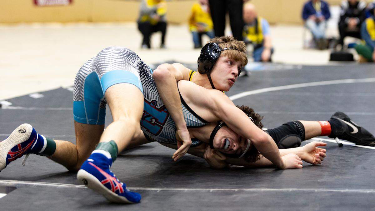 Harrison County’s Jackson Wells looks to his coaches as he holds Union County’s Jaxson Mayberry under control during the 113 class finals Saturday.