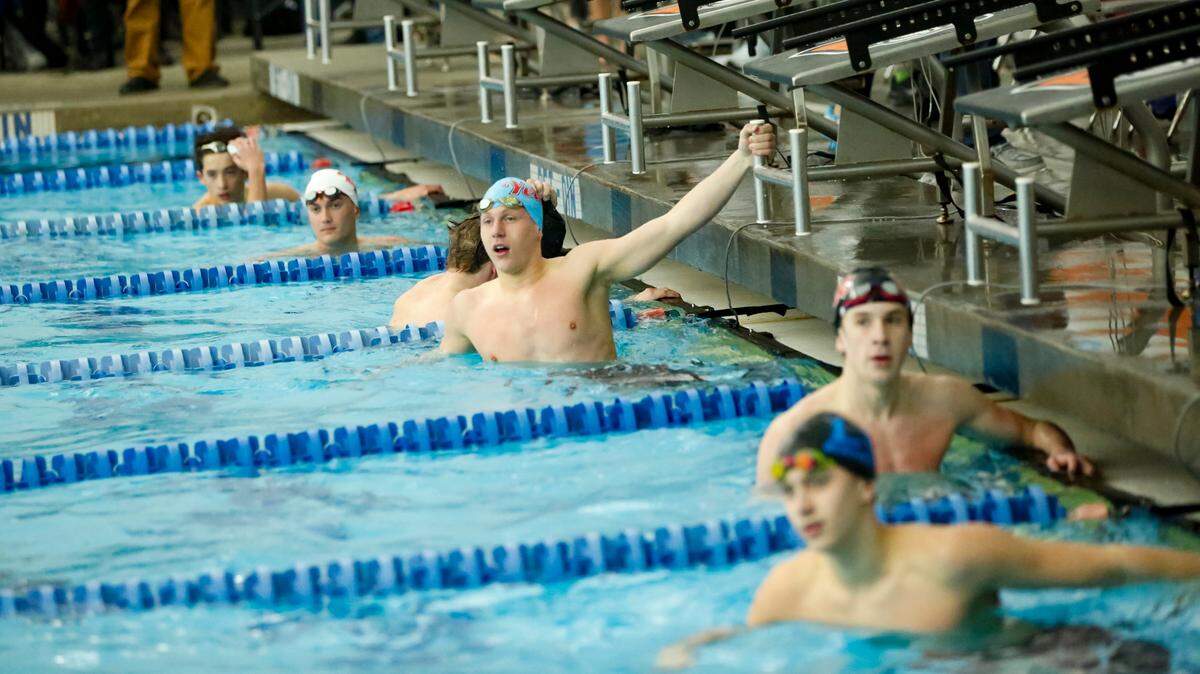 Lafayette’s Isaac Barrow, center, listened to the results after the 50-yard freestyle, which he won by less than a tenth of a second over Lexington Catholic’s Wil Jones at the Region 8 Swimming and Diving Championships at Stivers Aquatic Center in Barbourville on Saturday.