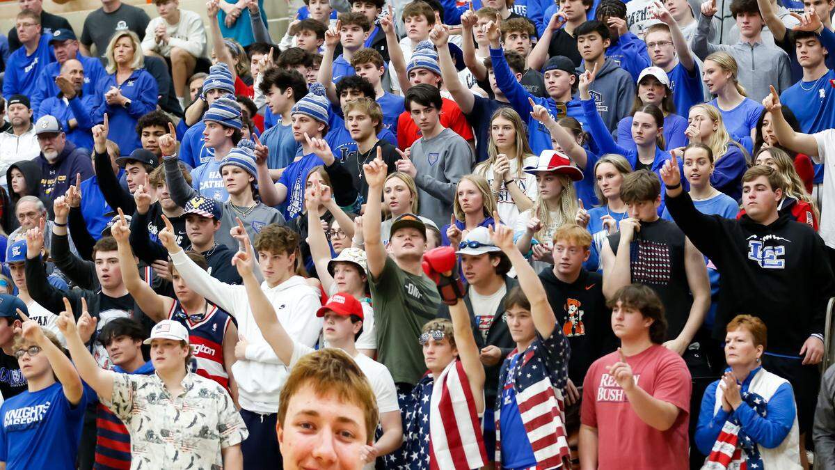 Lexington Catholic’s student section prepared to celebrate a Knights free throw in the second half against Frederick Douglass in the boys 11th Region Tournament semifinals at Paul Laurence Dunbar on Saturday.