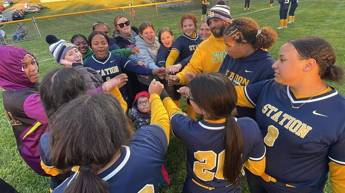 Bryan Station Coach Hector Urbaneja, right of center, celebrates with his softball team after their 7-4 win at Scott County on Tuesday night. The win snapped a 34-game losing streak to the Cardinals dating to 2006.