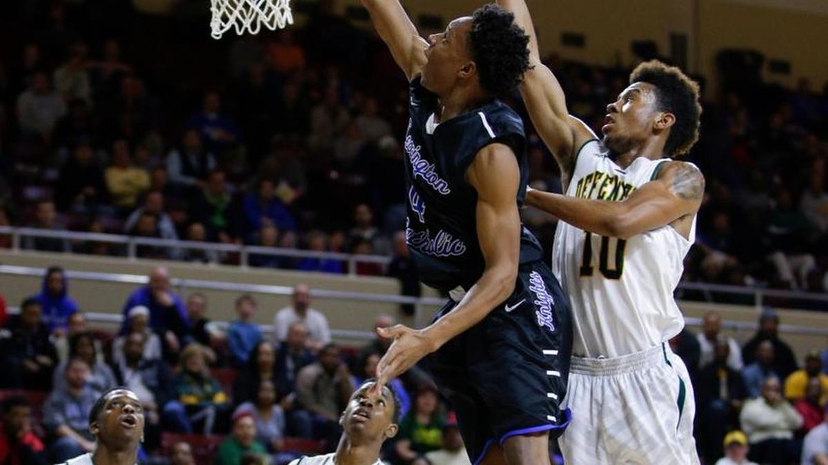 Lexington Catholic's Joseph Ogbogu scored in front of Bryan Station's Tim Dunn as Lexington Catholic defeated Bryan Station 56-53 in the 11th Region championship on Tuesday March 10, 2015 in Richmond, Ky.