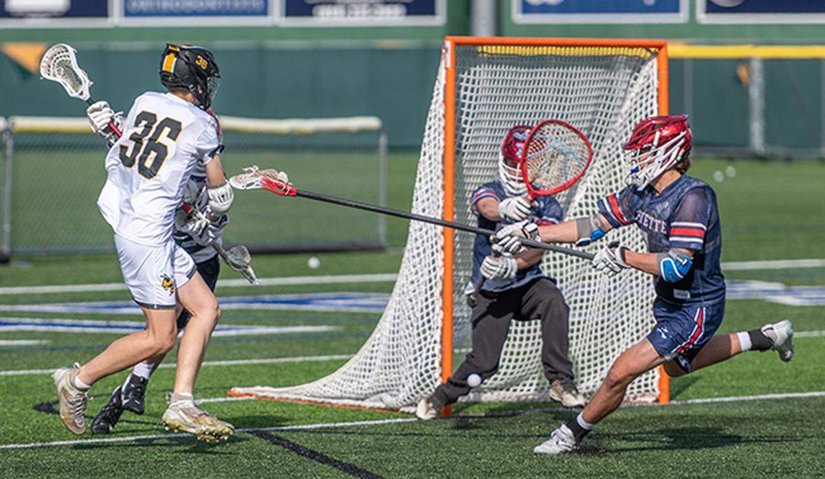 Woodford County’s Drew Sumner (36) scores on Lafayette’s defense during the Yellow Jackets’ win in the 8th Region boys lacrosse semifinals at Lexington Catholic High School on Saturday.