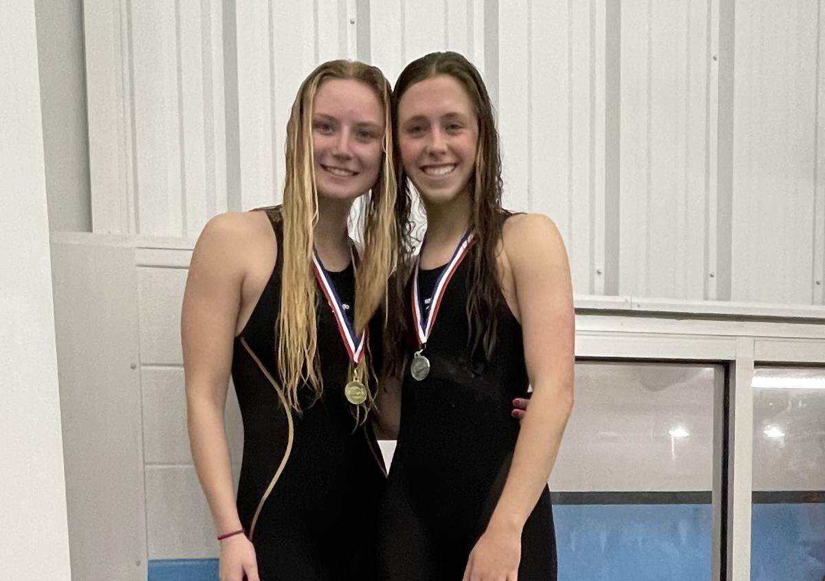 Lexington Catholic’s Lillian Hosinskin, left, and Caroline Beiting each got an individual win in the Region 8 Swimming Championships on Saturday at Stivers Aquatic Center in Barbourville.