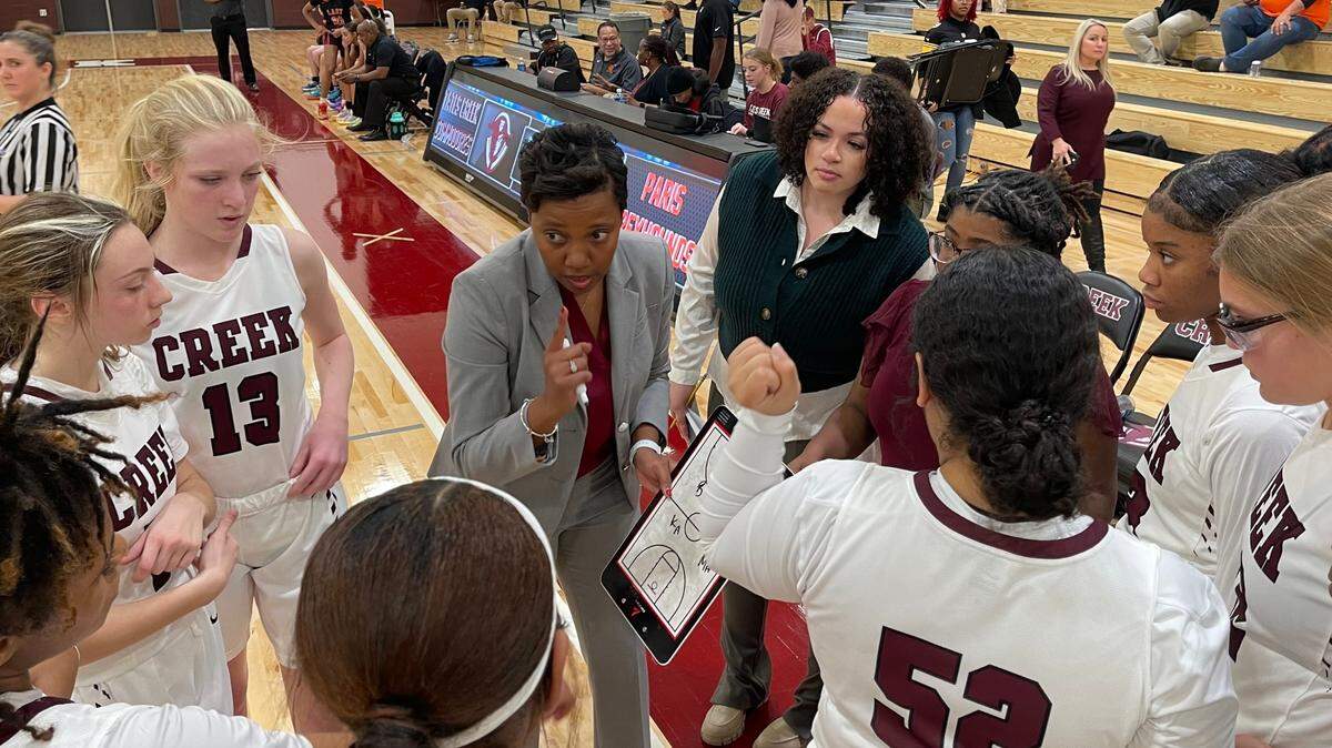 New Tates Creek girls’ coach Jana Costner speaks to her team during a timeout in their season opener against Paris last week.