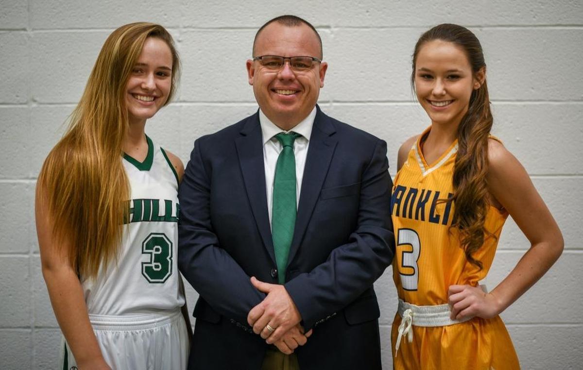 Montana Muravchick, left, a senior at Western Hills High School, Brandon Muravchick, the head coach of the Western Hills High School girl's basketball team and Jaylin Muravchick, a freshman at Franklin County High School, pose together before the Western Hills and Franklin County basketball game.