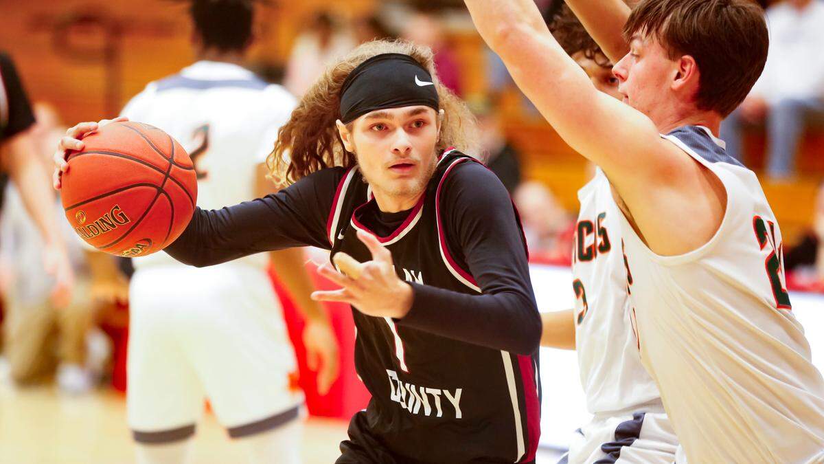 Harlan County’s Reggie Cottrell (1) drives into the lane against the defense of Frederick Douglass forward Logan Busson, right, during their Jock Sutherland Classic game at Lafayette High School on Saturday.