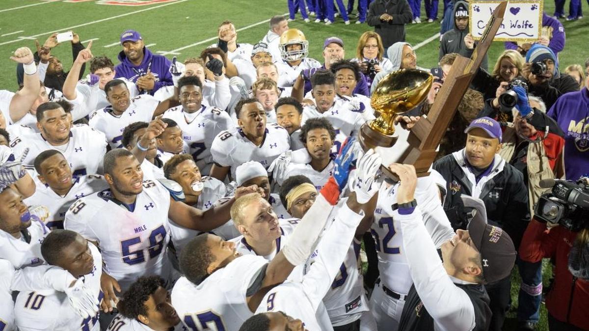 Louisville Male’s head coach Chris Wolfe hoisted the state trophy. Lafayette lost 41-14 to Male in the 6A State Championship on Saturday Dec. 5, 2015, in Bowling Green, Ky.