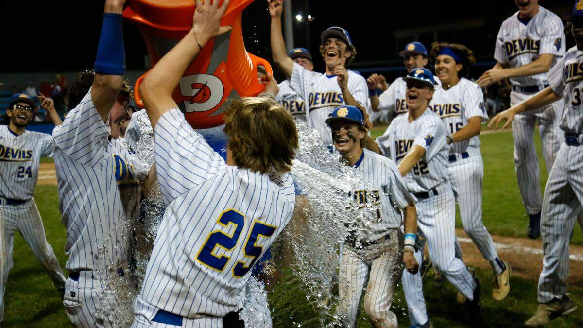 Henry Clay’s baseball team made sure head coach Jordan Tarrence (under bucket) got a good celebratory soak after the Blue Devils defeated Scott County 8-4 to win the 42nd District Tournament championship on their home field on Tuesday.
