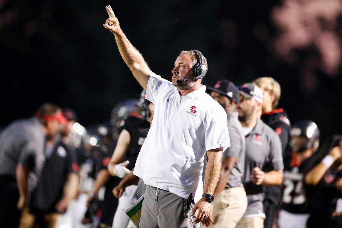 Paul Laurence Dunbar head coach Wesley Johnson motions down field during a game against Breathitt County in Lexington on Aug. 20, 2021. Dunbar won 69-28.