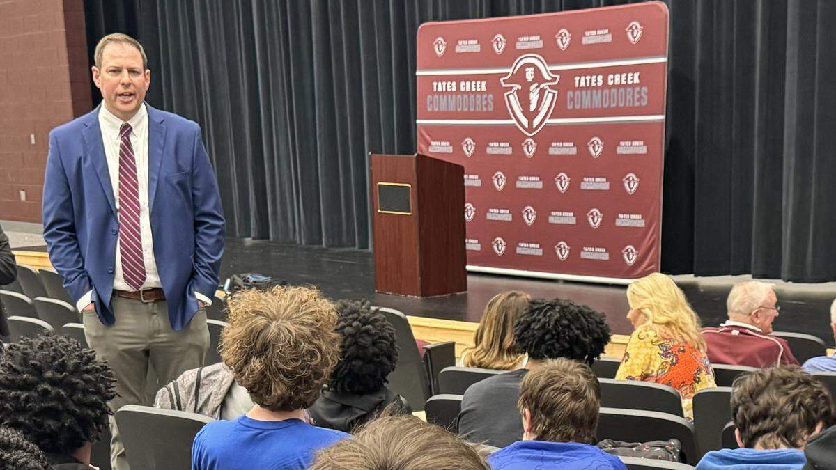 Tates Creek High School’s new boys basketball head coach Keaton Belcher, left, spoke with members of the team during his introduction at the school on Tuesday.