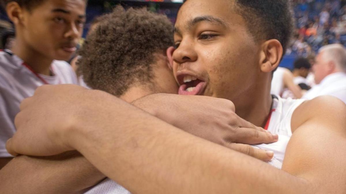 Owensboro’s Jacoby Harris and Airus Phillips, right, hug Sunday, March 22, 2015, after winning the state championship in the KHSAA Boys' Sweet Sixteen Basketball Tournament championship game in Lexington, Ky.