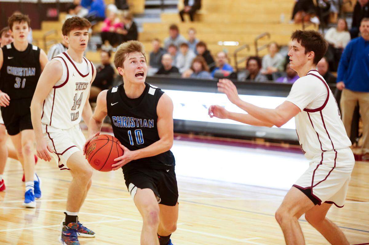 Lexington Christian’s Saxton Howard (10) drives for a layup in the second half against Tates Creek’s Tom Haubenreich, right, as another Commodore, Luke Ratliff (14), trails the play during their game at Tates Creek High School on Tuesday.