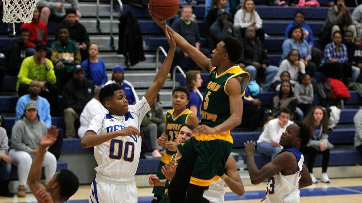 Bryan Station's Eric Boone shot against Henry Clay’s Quentyn Jackson in a game last month. Boone hit a half-court shot at the buzzer Thursday night to beat LCA 64-63.