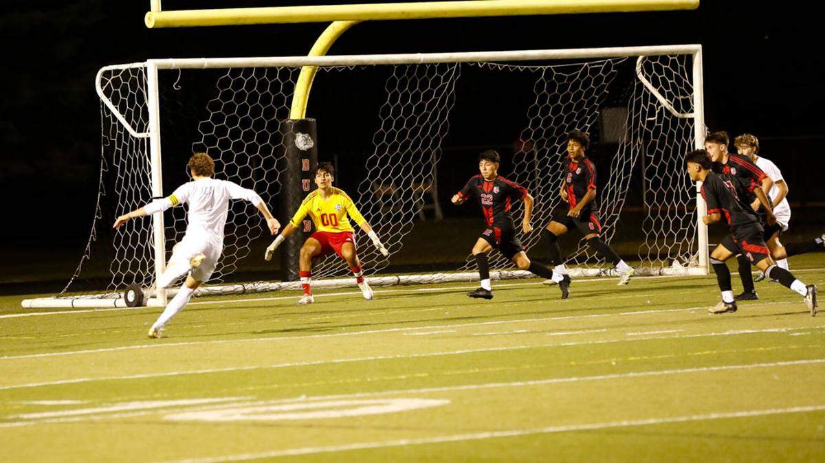 Henry Clay’s Marco Messerli, left, steps into a shot he blasted through the opposite side netting for his second goal of the game and a 2-0 lead at Paul Laurence Dunbar High School on Tuesday.