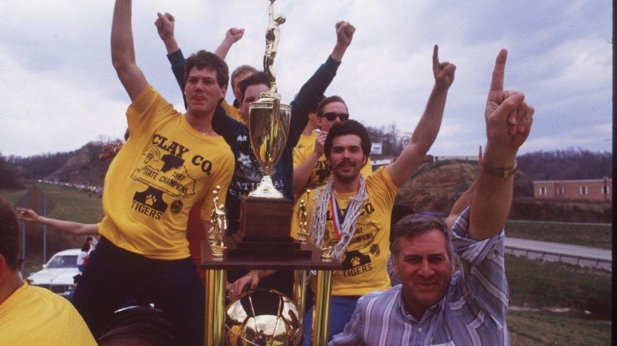 Clay County Coach Bobby Keith, front, and players rode through Manchester on a fire truck in celebration of the Tigers winning the 1987 boys’ Sweet Sixteen championship. It was the first boys’ basketball state title for a team from the Eastern Kentucky mountains since Carr Creek in 1956.