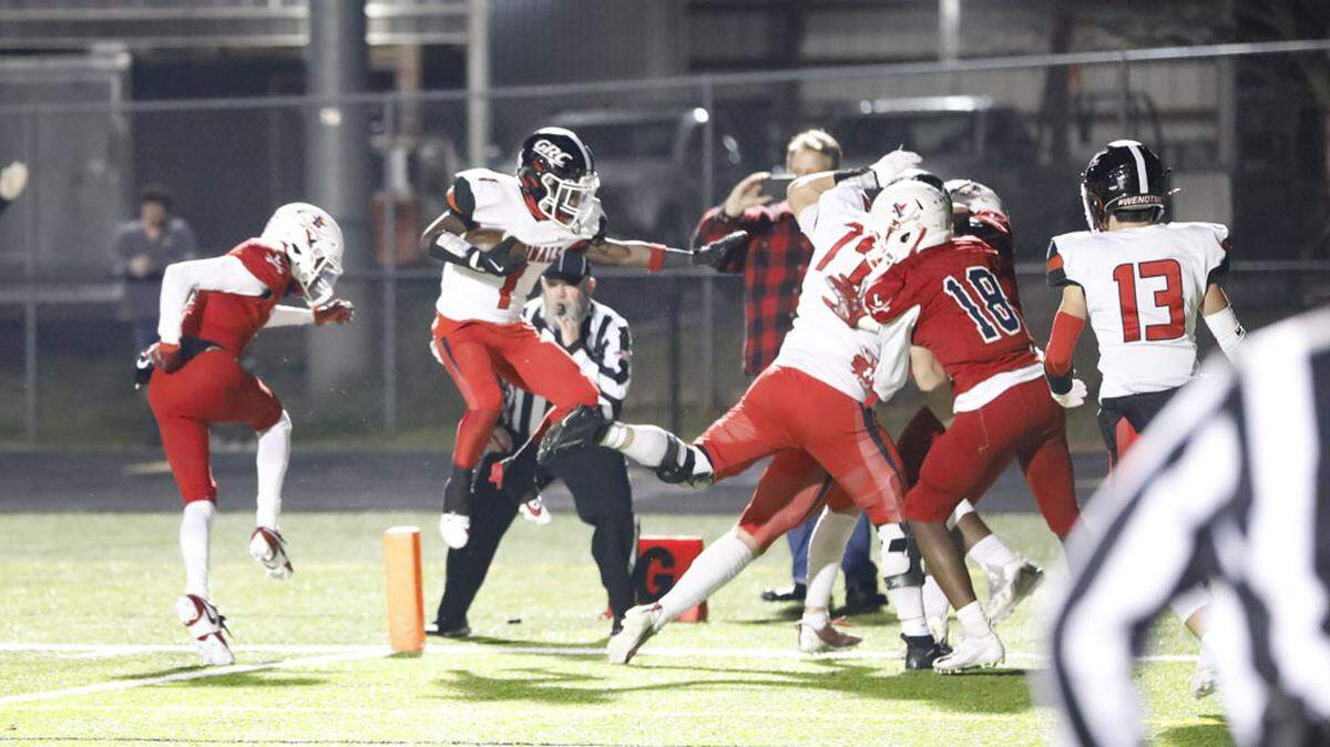 George Rogers Clark’s Yeremiah Israel (1) leaps into the end zone to help put the Cardinals up 14-6 in the second half against Lafayette in their Class 6A first-round playoff game.