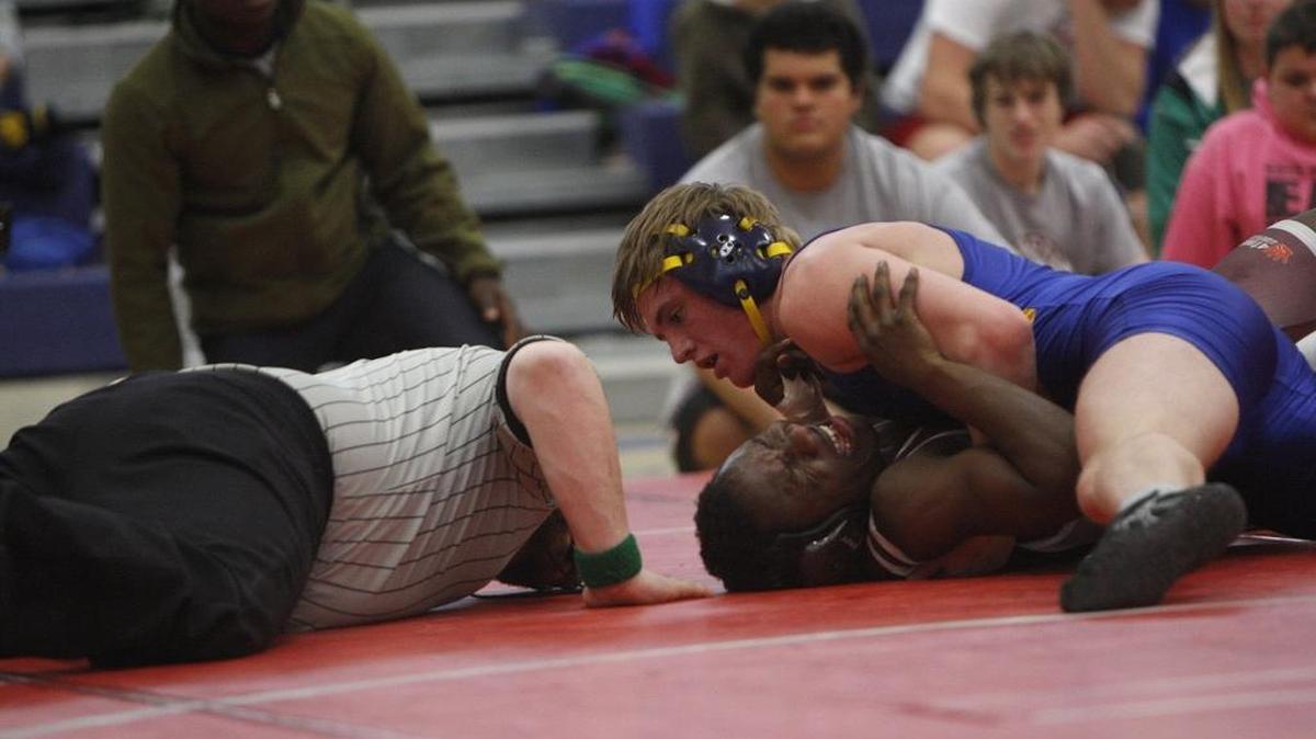 Henry Clay’s Evan Cannon wrestled Tates Creek’s Chubaka Mutayungwa, in burgundy, in the 160-pound class in the Fayette County championships on Saturday.