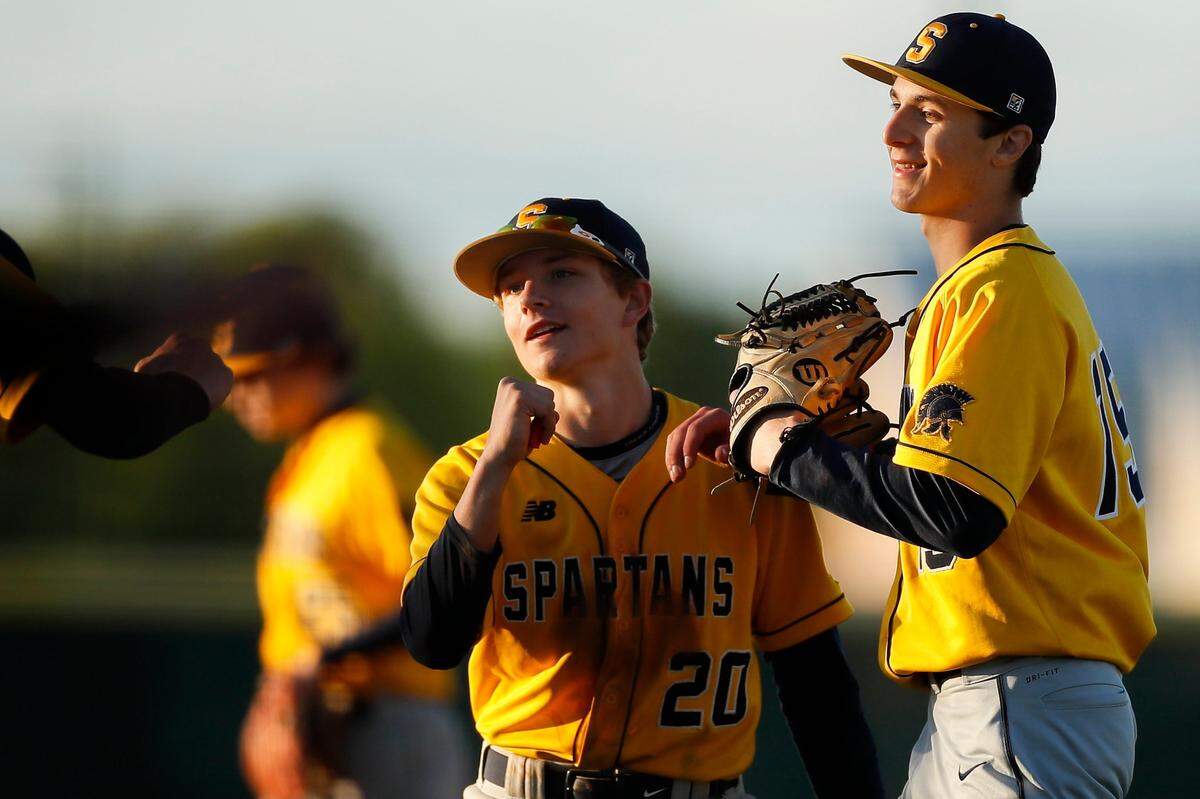 Sayre’s Dirk Visser, left, and Raymond Saatman (15) celebrate after a win against Frederick Douglass on May 5, 2021. Saatman hit .393 with 24 RBI and was 5-5 with a 2.37 ERA last season.