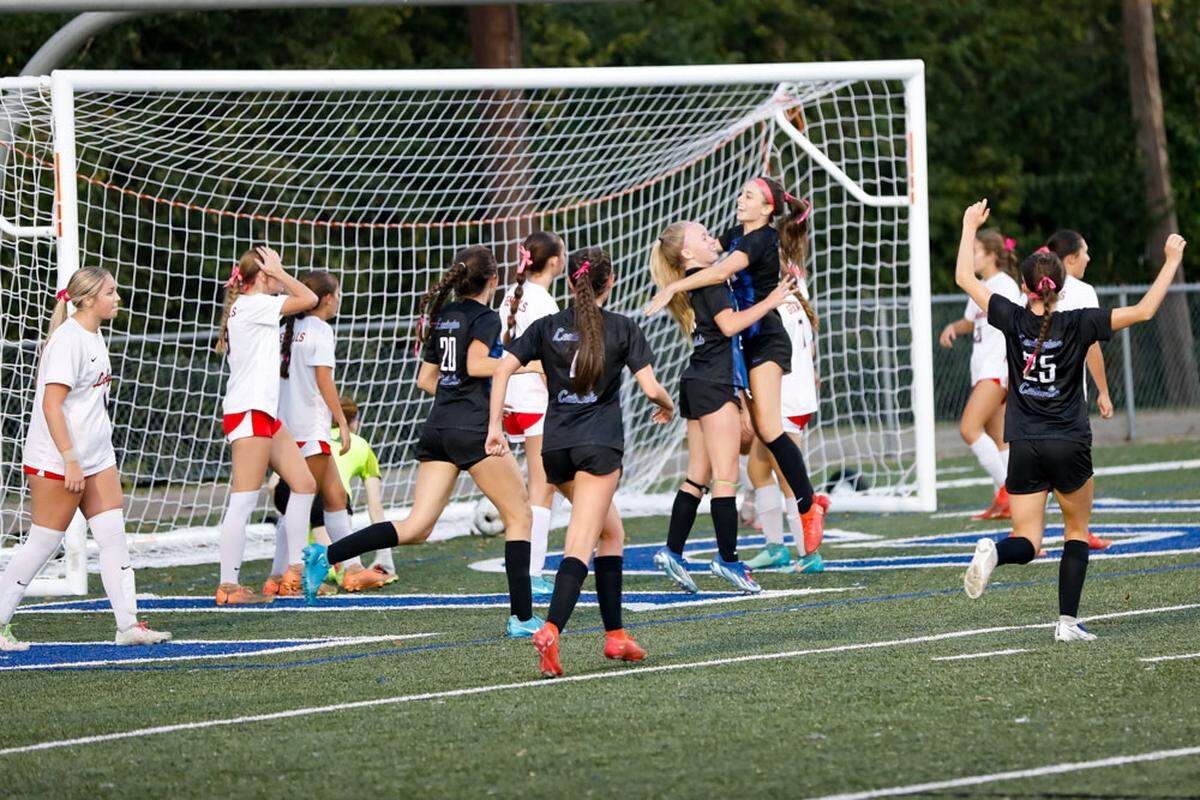 Lexington Catholic’s Izzy Skinner leapt into the arms of teammate Harper Ward after Ward scored the opening goal of the Knights’ 2-1 overtime win over Lafayette in the girls 43rd District Tournament championship game at Lexington Catholic High School on Thursday.