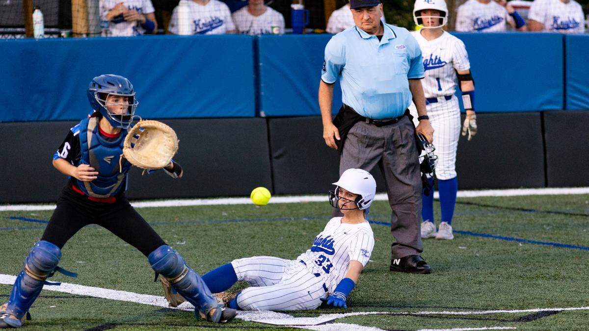 Lexington Catholic’s Aevea Mosley-Franklin slides home safely for the game-winning run as Lafayette catcher Skyler Davis awaits the throw home during the Knights’ 2-1 win at Lexington Catholic High School on Monday.