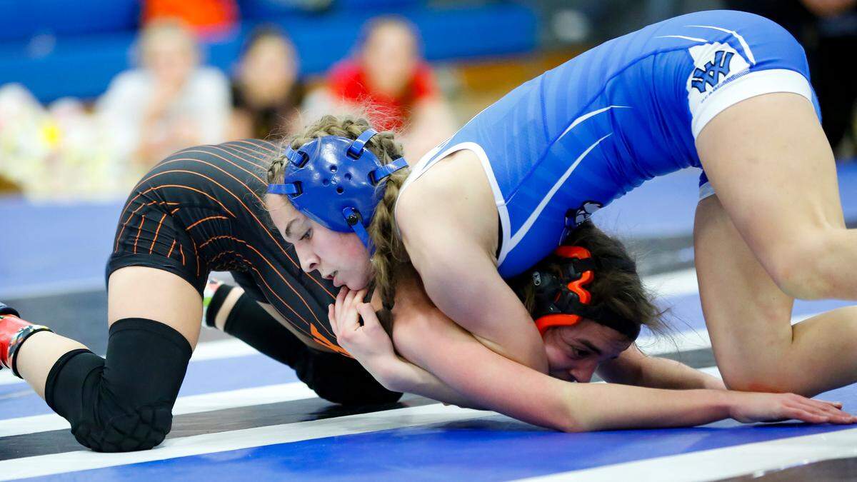 Walton Verona’s Emma Moore, right, won her second consecutive 100 division title and most outstanding wrestler award after her match victory over Ryle’s Peyton Brinkman at the Girls Region 8 Wrestling Championships at Walton-Verona High School in Walton on Saturday.