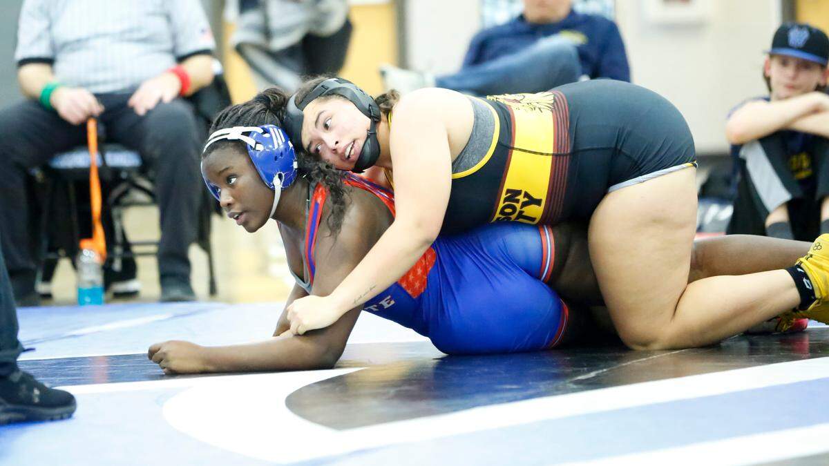 Lafayette’s Elene Niyogoshima, left, looks to her coach as she tries to escape the hold of Harrison County’s Layla Davis in the 235 division of the Girls Region 8 Wrestling Championships at Walton-Verona High School in Walton on Saturday.