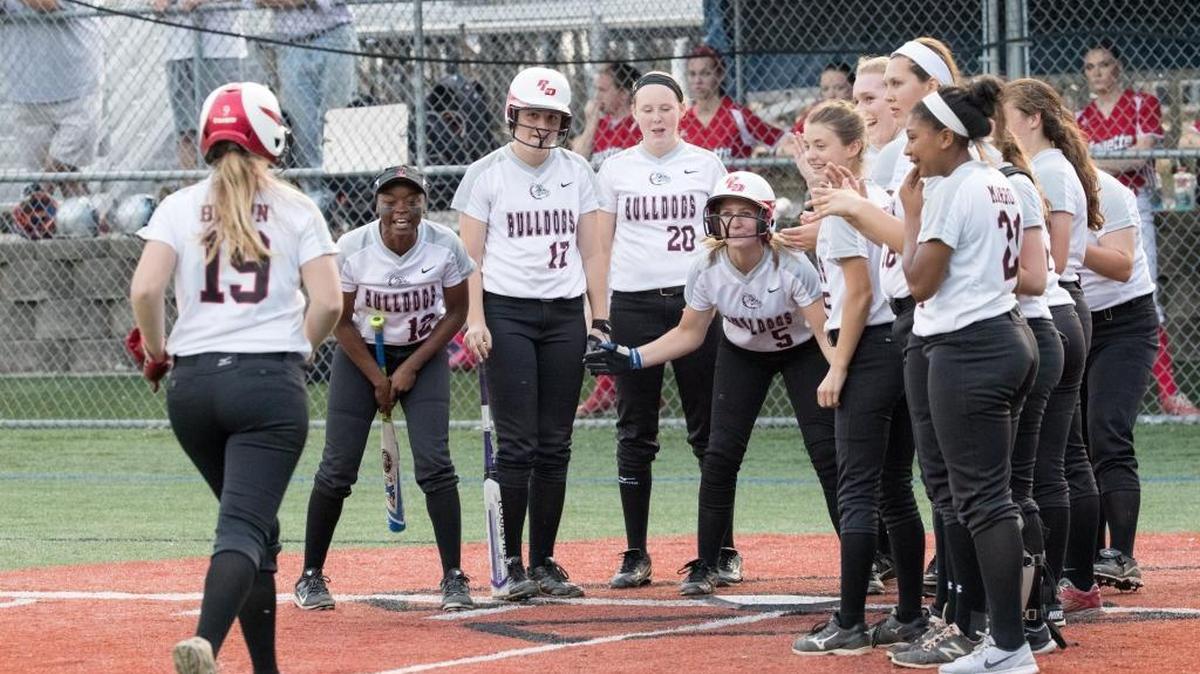 Dunbar's Riley Brown (19) was greeted by teammates after hitting a home run as Dunbar defeated Lafayette 9-1 in the Championship game of 43rd District high school softball tournament at Lexington Catholic High School on Wednesday May 25, 2016 in Lexington, Ky.