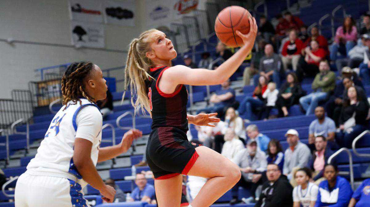 George Rogers Clark guard Kennedy Stamper went up for a reverse layup against Henry Clay’s Timarri Miller during their game at Henry Clay High School on Feb. 20. The Cardinals will face three-time defending state champion Sacred Heart Academy in the first round of the Girls’ Sweet 16 on Thursday.